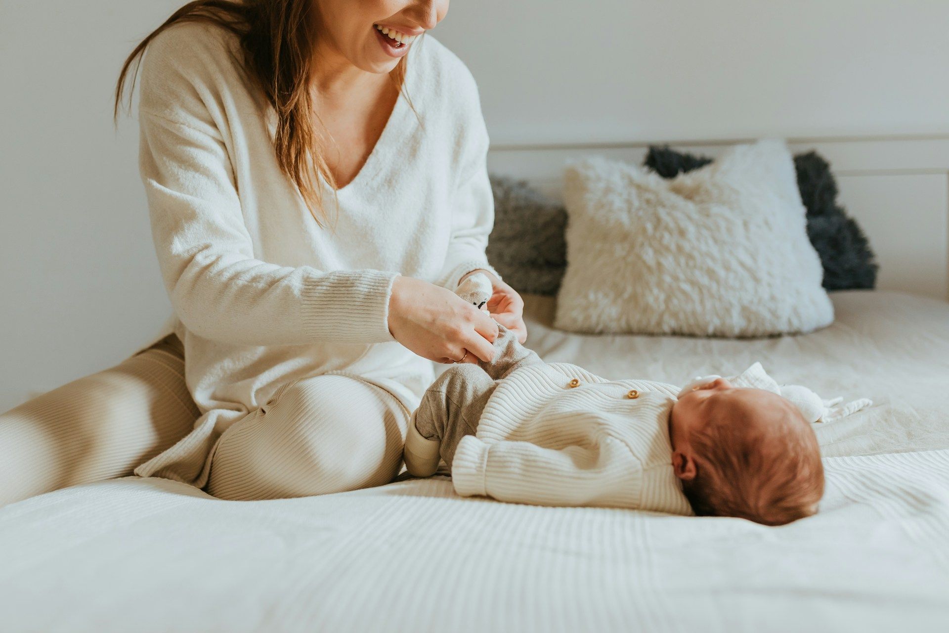 Mother dressing her newborn